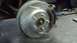 1996 Ford Taurus - Close-up of a drilled and slotted brake rotor and caliper, likely a replacement part.