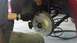 1996 Ford Taurus - A person is shown installing a new drilled and slotted brake rotor onto a vehicle's wheel hub.