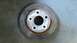 1996 Ford Taurus - A single brake rotor is shown resting on a concrete surface.