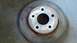 1996 Ford Taurus - A single brake rotor is shown, with rust and wear evident on its surface.