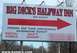 1979 Ford Bronco - A billboard for Big Dick's Halfway Inn Resort advertises rental homes and a gift shop with a large red arrow.