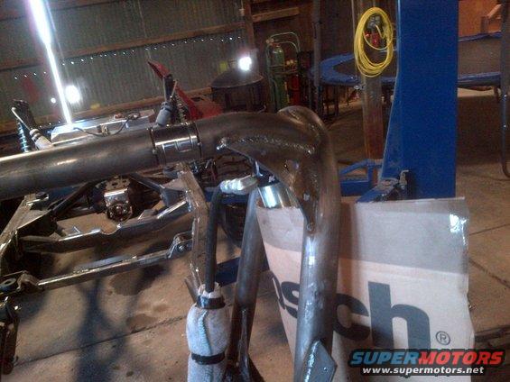 Custom exhaust pipe and chassis in workshop