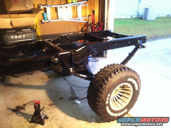 Vehicle frame with a large off-road tire and silver rim