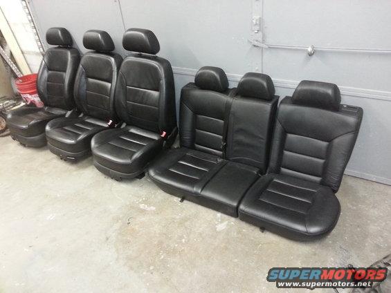 Set of black leather car seats, including front bucket seats and rear bench seats