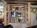 2004 Aston Martin Virage - Organized garage storage cabinet containing automotive supplies and manuals.