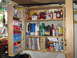 2004 Aston Martin Virage - A well-stocked garage shelf unit displays a variety of automotive maintenance products and reference materials.