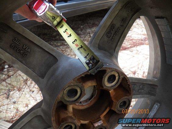 Measuring tape on a wheel showing markings like JIL VIA 690KG and ET-40