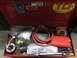2004 Aston Martin Virage - A red toolbox is open, revealing a collection of tools and equipment, including a coiled red hose and a pipe threading tool.