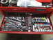 2004 Aston Martin Virage - A red toolbox drawer is organized with a variety of sockets, ratchets, and other mechanical tools.