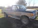1988 Ford F-250 - This 1988 Ford F-250 pickup truck is shown in a three-quarter front view under a clear sky.