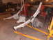 1988 Ford F-250 - Vehicle axles and leaf springs are suspended by a hoist in a workshop environment.