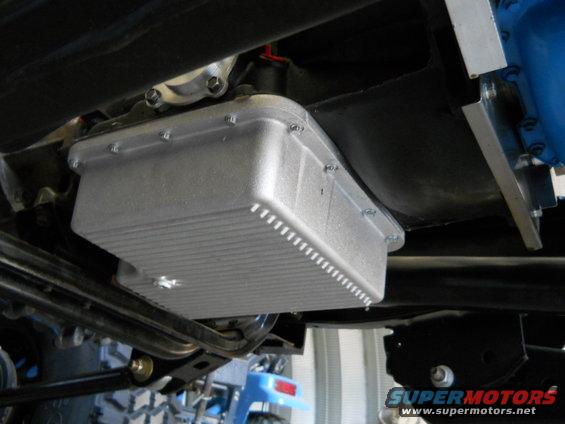 close-up of aftermarket transmission oil pan bolted to underside of vehicle