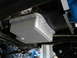 1992 Ford Bronco - Underside view of a vehicle's transmission oil pan, showing its ribbed design and bolted construction.