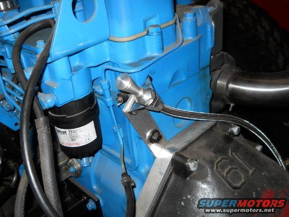 Close-up of a blue engine block with a black filter and metal fittings