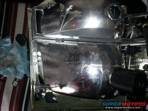 Two vehicle headlight assemblies, one marked RH, with part numbers visible