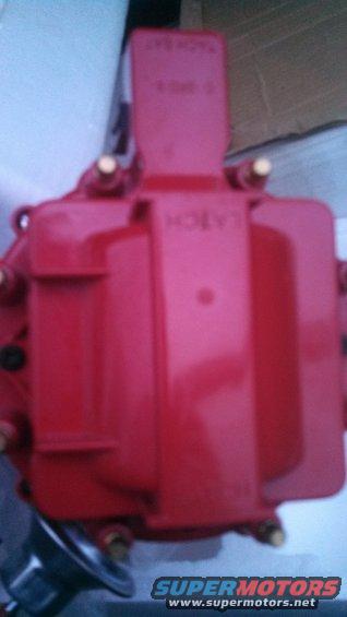 red ignition coil with some text on top
