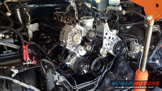 Engine being worked on, possibly during a rebuild. It's suspended by a chain and hoist