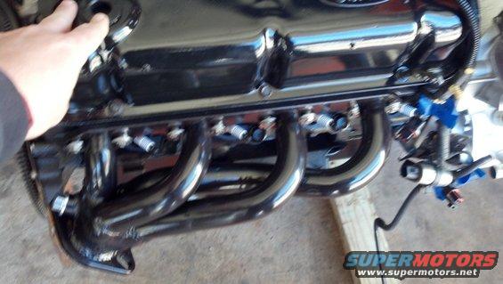 Close-up of a Ford engine's valve cover and exhaust headers