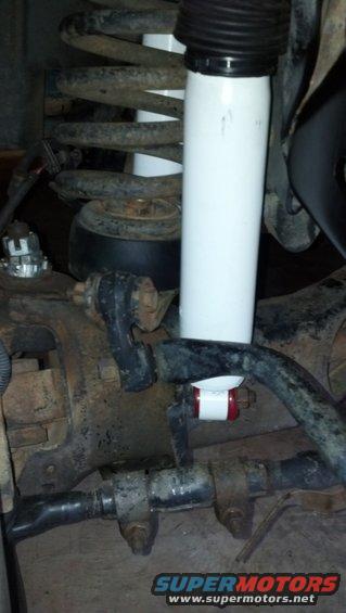 White shock absorber and coil spring assembly with red and white stabilizer