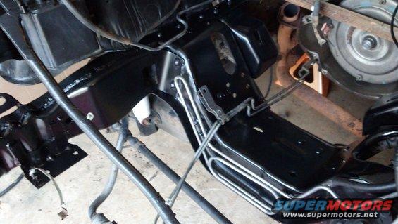 Close-up of vehicle frame and transmission assembly, possibly during a rebuild