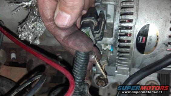 Alternator wiring harness disconnected, showing Remy New label with part number 92323