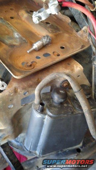 Wire brush attachment on rusty battery tray