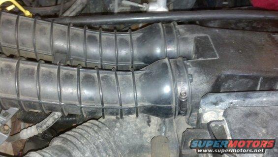 Two black ribbed air intake hoses connected to a black box