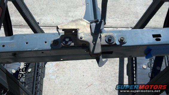 Close-up of a vehicle's frame section with a latch mechanism attached