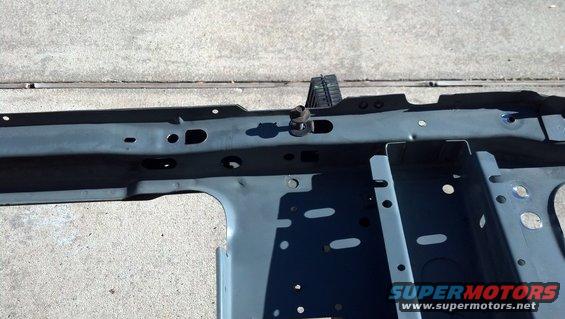 Gray metal frame rail section with bolt and bracket