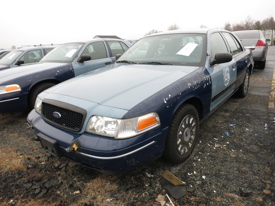 Light blue and dark blue Ford Crown Victoria, front quarter view