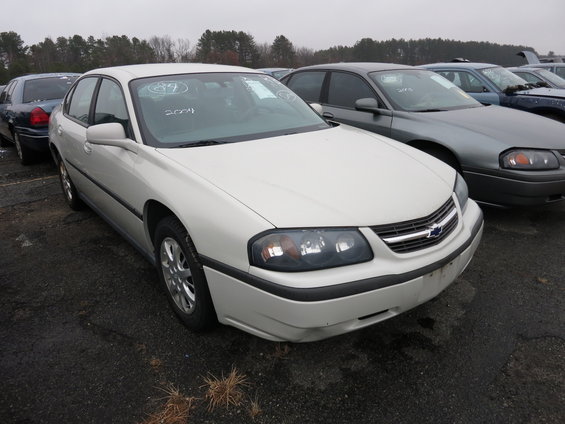 White Chevrolet Impala sedan parked in a lot, front 3/4 view. Text '89' and '2004' written on windshield
