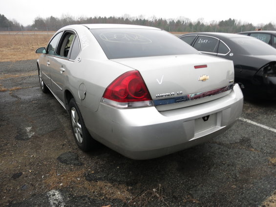 Silver sedan, rear 3/4 view, with 'Impala LS' badging and a Chevrolet emblem