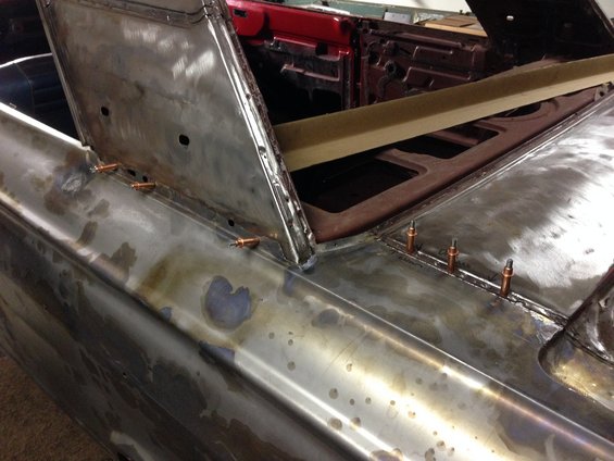 1964 Ford Fairlane body panels undergoing repair, showing bare metal and welding spots