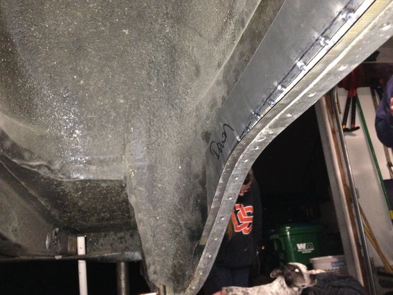 Undercarriage of a vehicle with a metal patch riveted to the wheel well