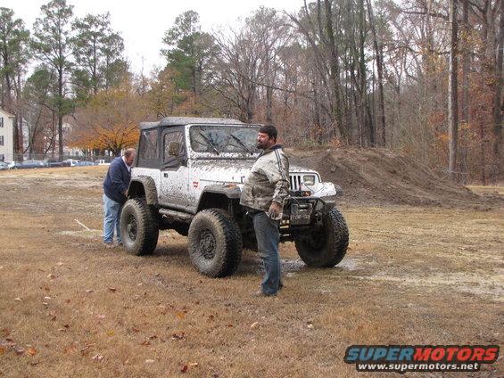White Jeep Wrangler with large tires and off-road modifications