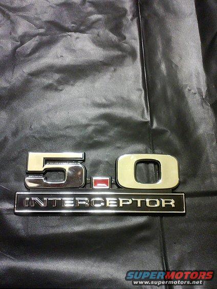 Chrome 5.0 emblem with red accent and INTERCEPTOR text on black fabric