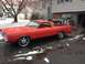1968 Ford Ranchero - A red 1968 Ford Ranchero pickup truck is seen parked in a driveway with snow falling around it.