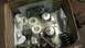1995 Ford Bronco - A box contains various automotive parts, including springs and metal components, ready for installation or repair.