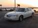 2002 Lincoln Town Car - A white 2002 Lincoln Town Car is parked near a waterfront during sunset.