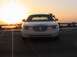 2002 Lincoln Town Car - A white Lincoln Town Car is parked facing the camera during a sunset.