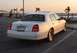 2002 Lincoln Town Car - Rear view of a white 2002 Lincoln Town Car parked near the water at sunset.