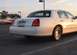 2002 Lincoln Town Car - Rear view of a white 2002 Lincoln Town Car with a license plate Arabic script.