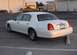 2002 Lincoln Town Car - A white 2002 Lincoln Town Car is parked at an angle, showing its rear and side profile.