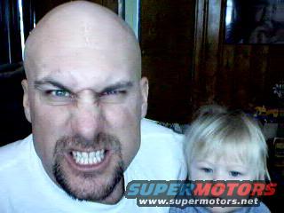 Man with goatee and child, Supermotors.net logo visible