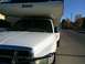 1997 Dodge 3500 - White pickup truck with a Lance camper shell parked on a residential street.