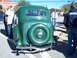 1971 Ford Ranchero - A green vintage car with a spare tire mounted on the rear is parked on a street with people around.