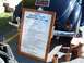 1971 Ford Ranchero - A sign details the custom build of a 1939 Deluxe Coupe Moonshine Special, parked outdoors.