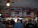 1971 Ford Ranchero - A diner scene framed photographs of vintage race cars displayed above the counter and menu boards.