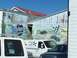 1971 Ford Ranchero - Mural on a building wall shows race cars and text related to racing history.