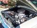 1971 Ford Ranchero - The engine compartment of a classic car is shown with the hood open, revealing the motor and surrounding components.